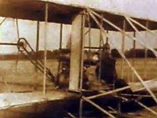 The world's first military airplane is demonstrated for the U.S. Army in 1909 by Orville Wright, shown here climbing into the pilot's seat. Wright and Lieutenant Frank Purdy Lahm are catapulted down a rail and launched into the air. The machine circles the field for 1 hour 12 minutes, setting a new world's record for time aloft with pilot and passenger.